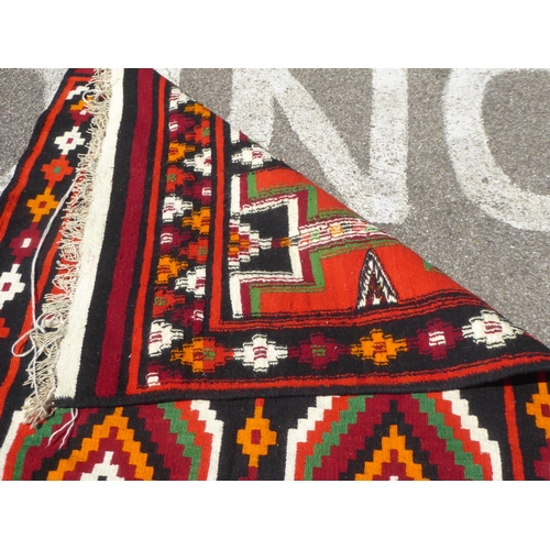 16 - A Kelim rug with geometric motifs, on a multi-coloured ground  52