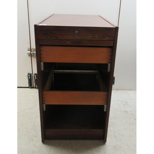 181 - A mid 20thC Scandinavian rosewood finished filing cabinet, the lockable vertically sliding tambour f... 