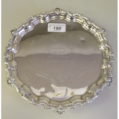 193 - A Georgian style silver waiter with a raised and decoratively cast piecrust border, elevated on scro... 