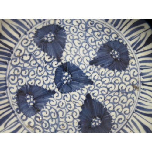 197 - A late 18thC Chinese Kangxi porcelain dish, decorated in blue and white with flowerheads and a borde... 