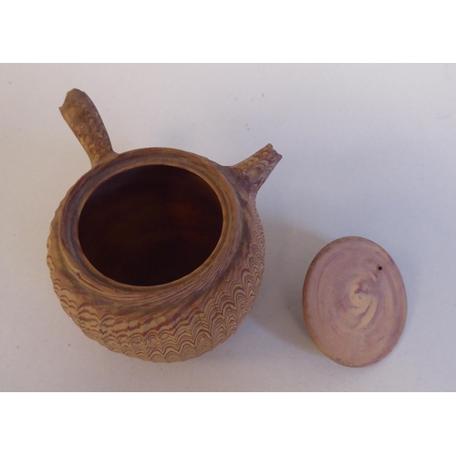 199 - An antique Japanese agate ware Saki pot of bulbous form with a short spout, side handle and cover