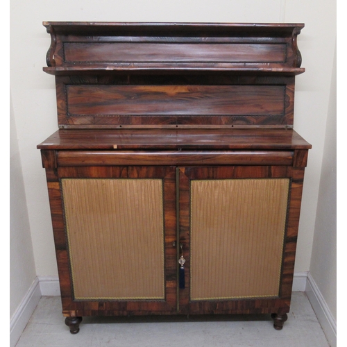200 - A Regency goncalo alves chiffoniere with bead carved borders, the shelved upper part over a pair of ... 
