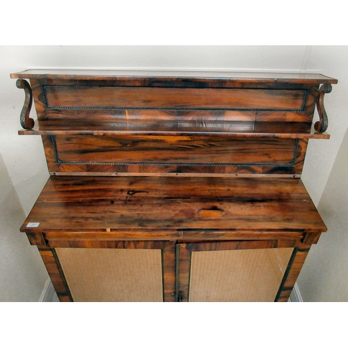 200 - A Regency goncalo alves chiffoniere with bead carved borders, the shelved upper part over a pair of ... 