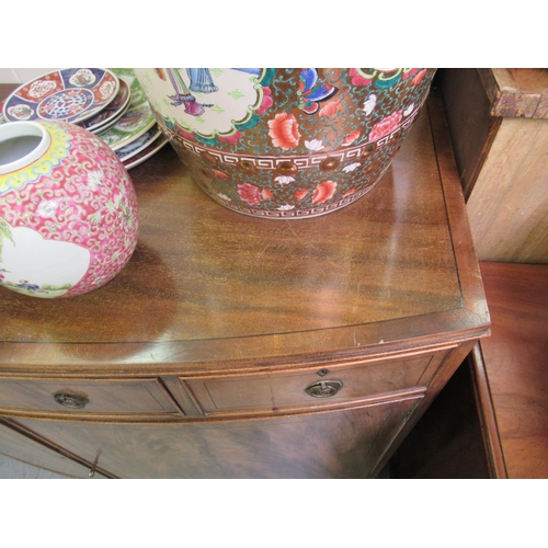 201 - A mid 20thC Hobbs & Co Regency design mahogany bowfront sideboard with three drawers and two doo... 