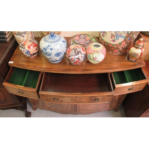 201 - A mid 20thC Hobbs & Co Regency design mahogany bowfront sideboard with three drawers and two doo... 
