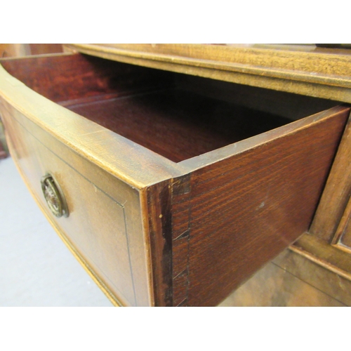 201 - A mid 20thC Hobbs & Co Regency design mahogany bowfront sideboard with three drawers and two doo... 