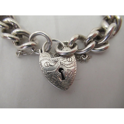 202 - A silver curb link bracelet, on a padlock clasp and safety chain&nbsp; mixed marks&nbsp;