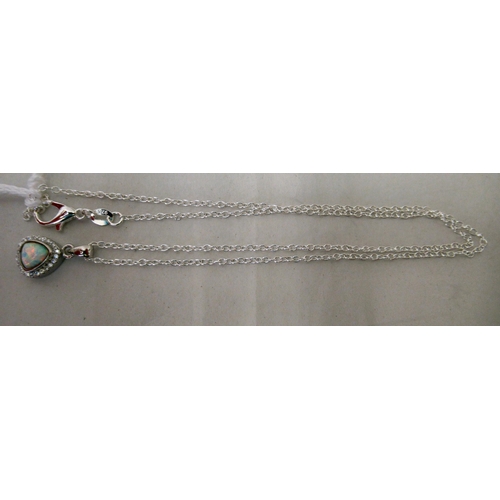 203 - A silver coloured metal pear shaped pendant, set with an opal and cubic zirconia, on a fine neckchai... 