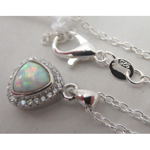 203 - A silver coloured metal pear shaped pendant, set with an opal and cubic zirconia, on a fine neckchai... 