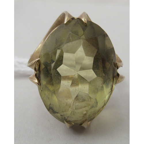 207 - A 9ct gold fancy claw set dress ring with a citrine coloured stone&nbsp;