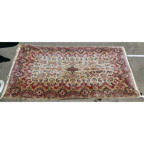 212 - A Persian design rug with dense floral motifs on a beige ground   124