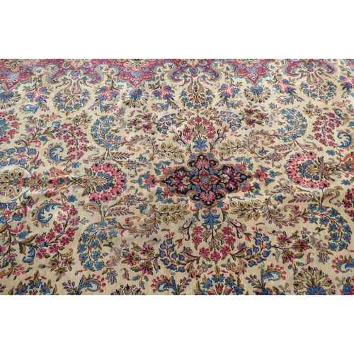 212 - A Persian design rug with dense floral motifs on a beige ground   124
