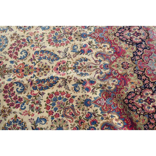 212 - A Persian design rug with dense floral motifs on a beige ground   124