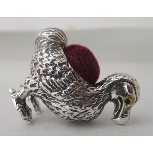 213 - A silver coloured metal novelty pin cushion, fashioned as a Dodo bird