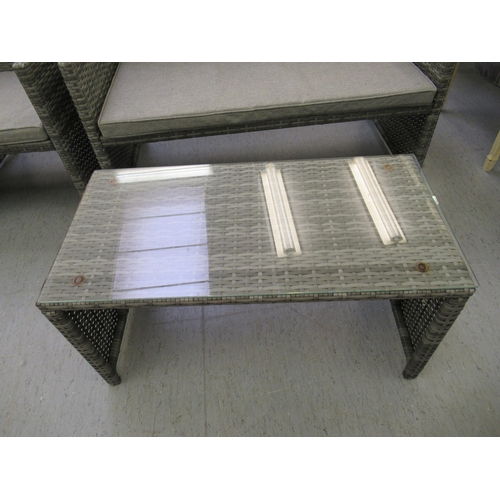 214 - A four piece grey coloured rattan terrace furniture set  comprising a two person settee, two arm cha... 