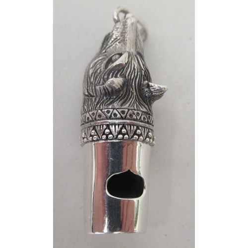 217 - A silver coloured metal whistle, fashioned as a dogs' head, on a pendant ring&nbsp;