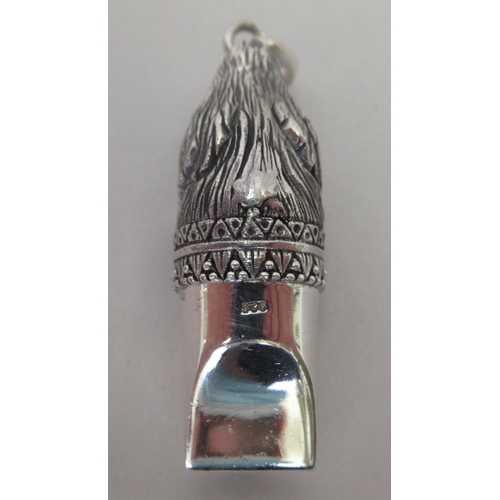 217 - A silver coloured metal whistle, fashioned as a dogs' head, on a pendant ring&nbsp;