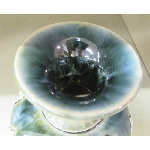 220 - A Royal Doulton green and blue glazed stoneware vase of baluster form, decorated with moulded floral... 