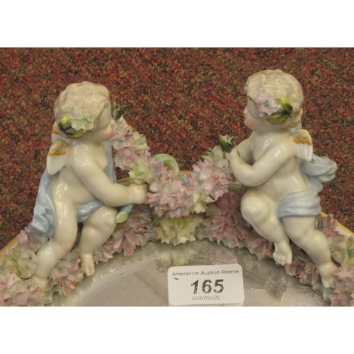 222 - A late 19thC (probably German) oval dressing table mirror, the bevelled plate set in a floral encrus... 