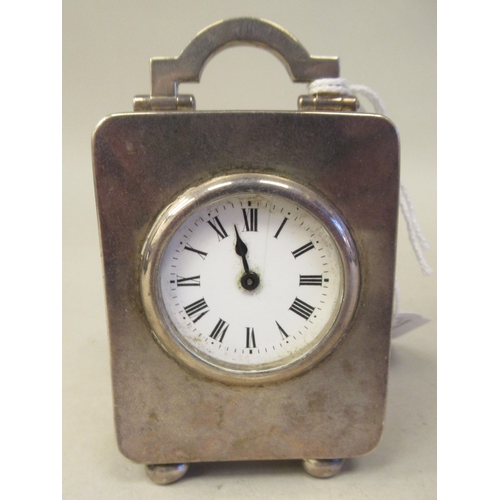 223 - An Asprey & Co traveller's miniature timepiece, the silver case of rectangular box design with a... 
