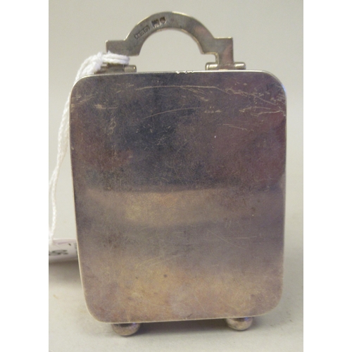 223 - An Asprey & Co traveller's miniature timepiece, the silver case of rectangular box design with a... 