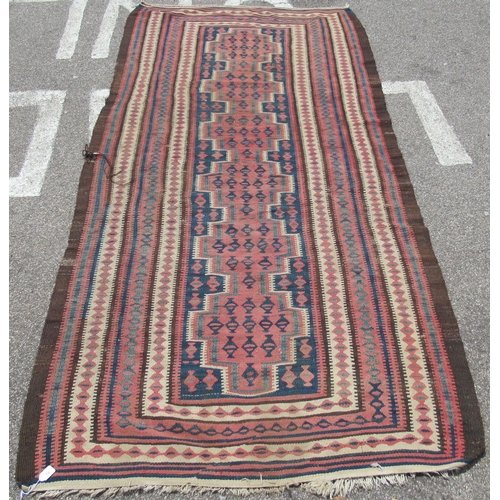 224 - A Turkish Kelim rug, decorated with repeating geometric and other designs, on a brown ground  54
