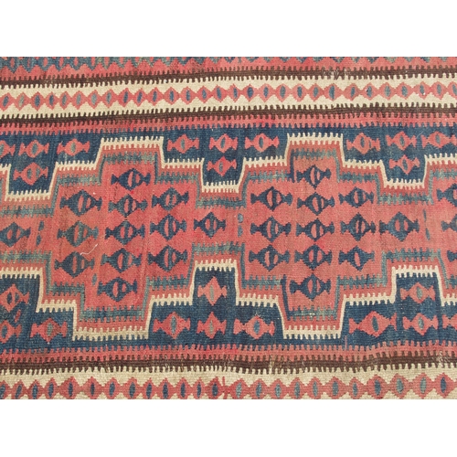 224 - A Turkish Kelim rug, decorated with repeating geometric and other designs, on a brown ground  54