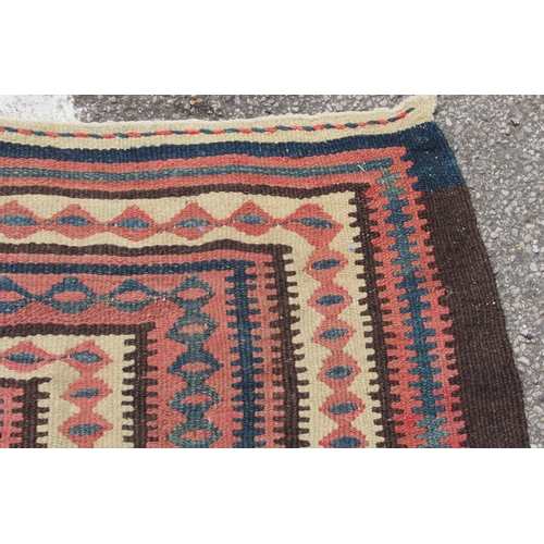 224 - A Turkish Kelim rug, decorated with repeating geometric and other designs, on a brown ground  54