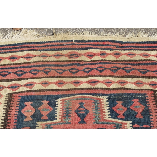 224 - A Turkish Kelim rug, decorated with repeating geometric and other designs, on a brown ground  54