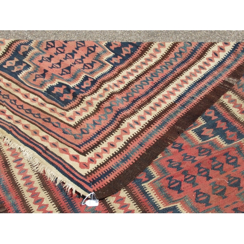 224 - A Turkish Kelim rug, decorated with repeating geometric and other designs, on a brown ground  54