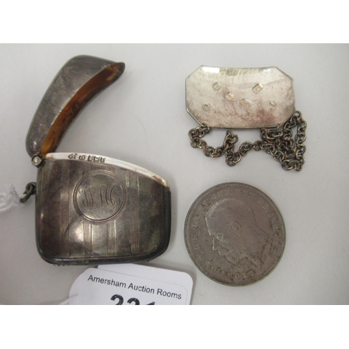 231 - A silver vesta case with a strike plate, a pendant ring and hinged lid; and a silver wine label&nbsp... 