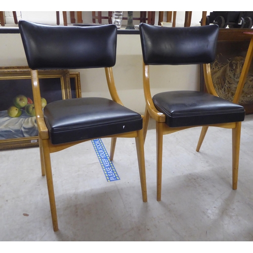 240 - A pair of 1950s/1960s Benchairs of Stowe beech framed dining chairs, each with a faux black hide bac... 