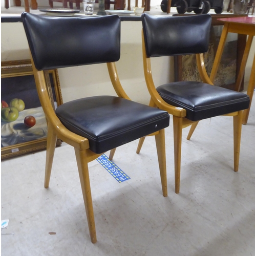 240 - A pair of 1950s/1960s Benchairs of Stowe beech framed dining chairs, each with a faux black hide bac... 
