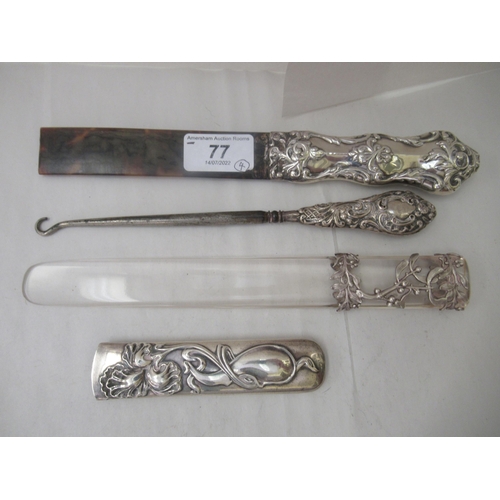 77 - Three early 20thC Art Nouveau silver page turner handles; and a contemporary silver handled button h... 