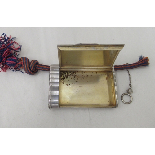 90 - An early 20thC G Keller French silver coloured metal cigarette case with a ribbed body and hinged li... 