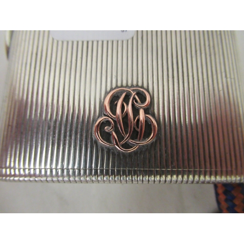 90 - An early 20thC G Keller French silver coloured metal cigarette case with a ribbed body and hinged li... 