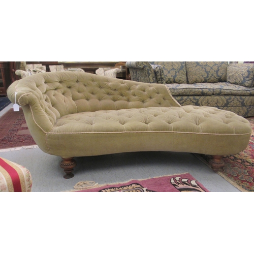 93 - An Edwardian chaise longue, later upholstered in green fabric, raised on turned feet