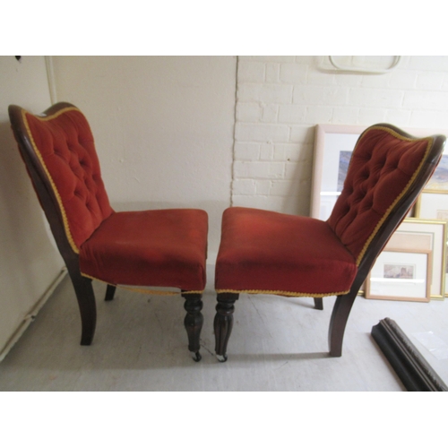 94 - A pair of late 19thC rosewood and mahogany showwood framed nursing chairs, the later part button red... 