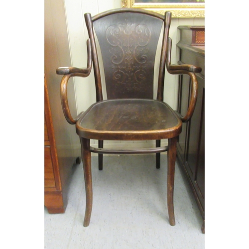 96 - An early/mid 20thC stained beech, panelled and bentwood framed open arm chair&nbsp;