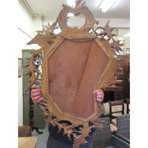 190 - A late 18th/early 19thC mirror, set in a carved giltwood, foliate scrolled and floral, rococo style ... 