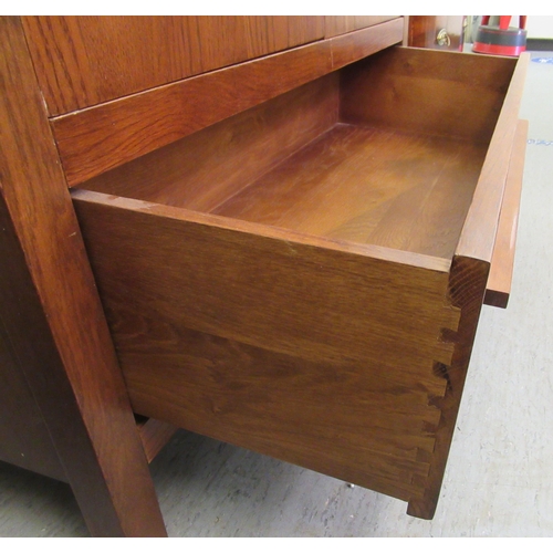 47 - A modern oak wardrobe with two doors and a drawer, raised on block feet&nbsp; 82