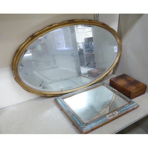 103 - A mixed lot: to include a modern mirror, the oval bevelled plate set in a moulded gilt frame  2... 