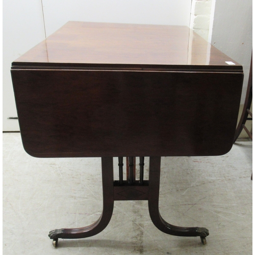 115 - A 19thC mahogany sofa table with ebony string inlaid decoration, the top having a reeded edge, over ... 