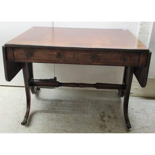 115 - A 19thC mahogany sofa table with ebony string inlaid decoration, the top having a reeded edge, over ... 