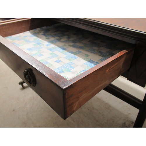 115 - A 19thC mahogany sofa table with ebony string inlaid decoration, the top having a reeded edge, over ... 