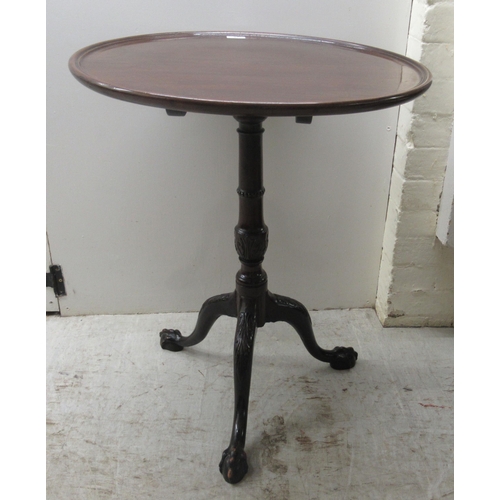 119 - A 19thC mahogany pedestal table, the turned top over a ring turned column with a foliate carved cabr... 