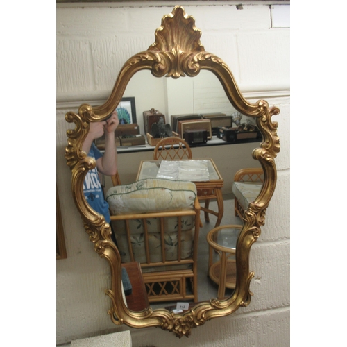 142 - A modern mirror, the shaped plate set in a Regency design moulded gilt frame  18