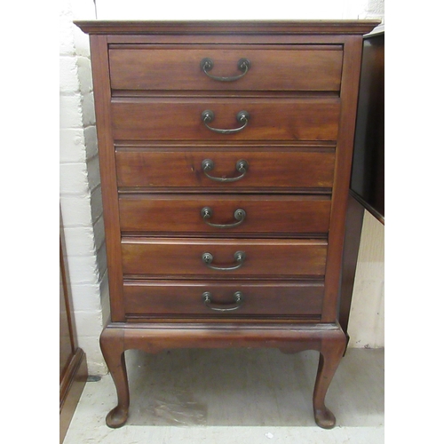 143 - A 1930s mahogany six drawer sheet music cabinet, raised on cabriole legs  34