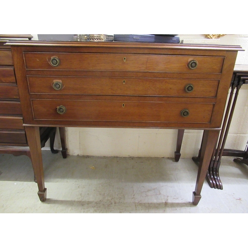 144 - An early 20thC mahogany three drawer serving table, raised on square, tapered legs and spade feet&nb... 