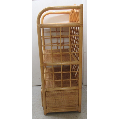 147 - A caned wicker three tier display unit with a base drawer  38